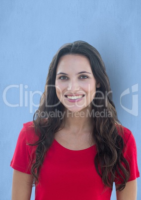 Young woman with long brown hair smiling over blue background