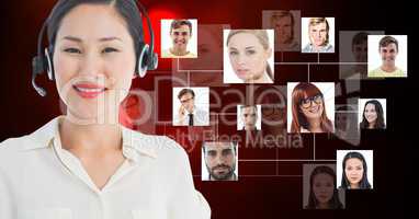 Smiling female customer care representative wearing microphone against flying business portraits