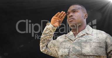 Soldier saluting against black background with grunge overlay and flare