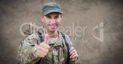 Soldier thumbs up with grunge overlay against brown background