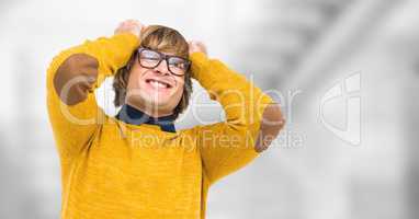 Frustrated male hipster pulling hair against blurred background