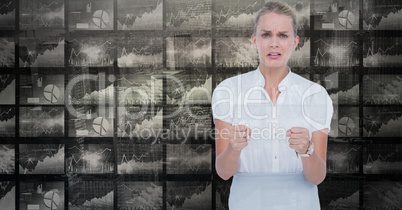 Woman showing fists against graphs