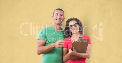 Portrait of smiling business people standing against yellow background