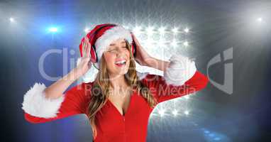 Woman in Santa costume listening to music on headphones