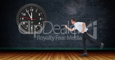 Businessman running with clock mounted on wall