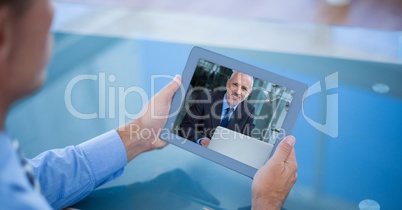 Cropped image of businessman having video call with colleague on tablet PC