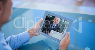 Cropped image of businessman having video call with colleague on tablet PC