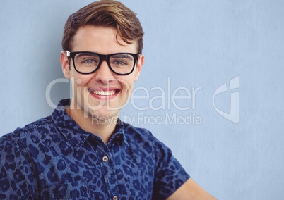 Male hipster wearing eyeglasses while smiling over blue background