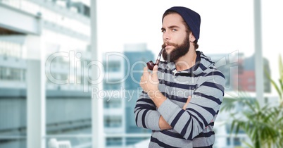 Confident hipster smoking pipe in city