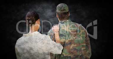 Back of soldier and wife against black grunge background with overlay