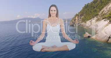 Double exposure woman meditating over lake