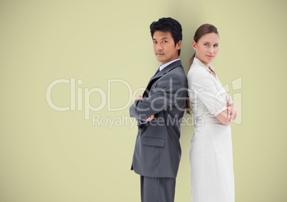 Side view of business people standing with arms crossed over colored background