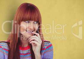 Happy redheaded female hipster looking away against yellow background