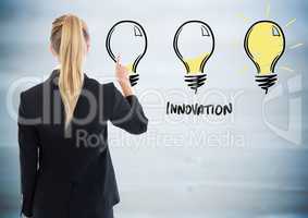 Back of business woman pointing at lightbulb doodle against blurry blue wood panel