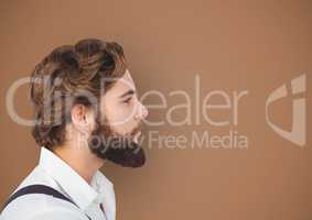 Side view of hipster with beard over brown background