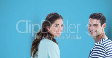 Happy male and female hipsters against blue background