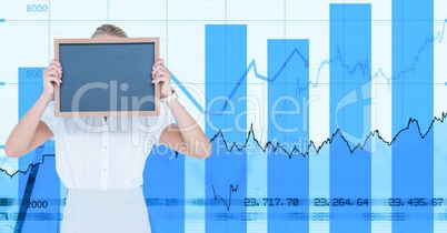 Businesswoman holding blank slate against graph