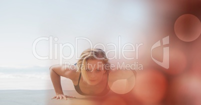 Woman doing push ups at beach