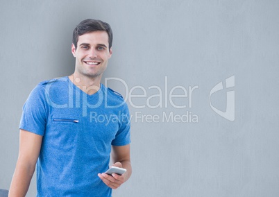 Male hipster holding smart phone over gray background