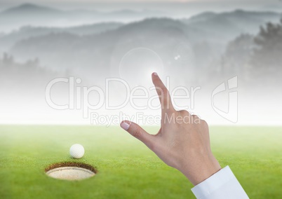 Womans Hand touching golf course mountains