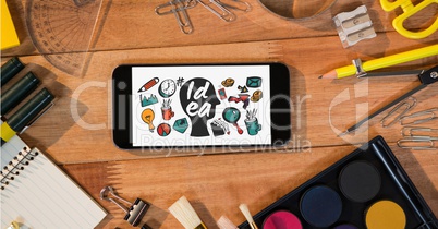 Idea icons on smart phone by stationery