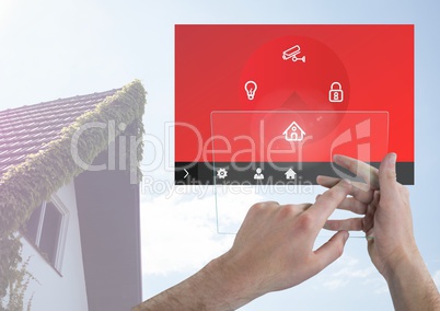 Hand touching a tablet and a home automation system App Interface