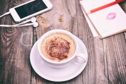 Cup of cappuccino on a gray wooden table