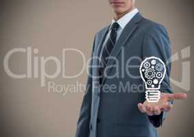Business man hand out with lightbulb doodle against brown background