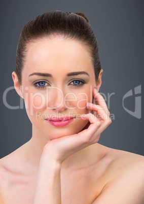 Close up of woman hand under chin against grey background