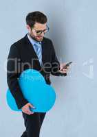 Businessman holding cloud shape while using smart phone