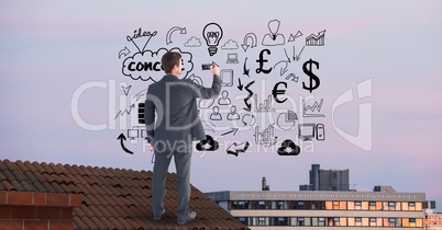 Rear view of businessman on roof drawing graphics in midair