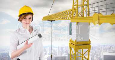 Female architect holding plan by crane
