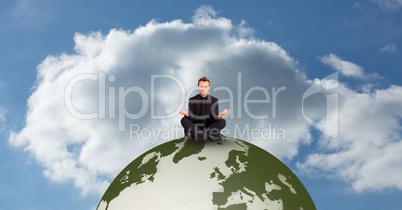 Man meditating on globe against sky