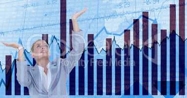 Businesswoman with arms raised against graphs