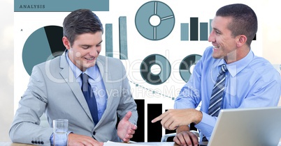 Smiling businessmen discussing against graphs