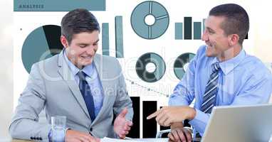 Smiling businessmen discussing against graphs