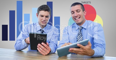 Businessmen using tablet PCs in office