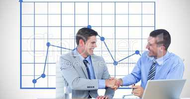 Businessmen shaking hands against graph