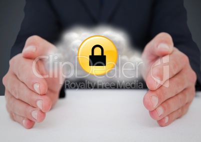 Business man at desk with cloud and yellow lock graphic between hands against grey background