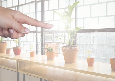 Hand pointing in air by window