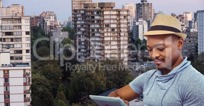 Man using digital tablet against cityscape