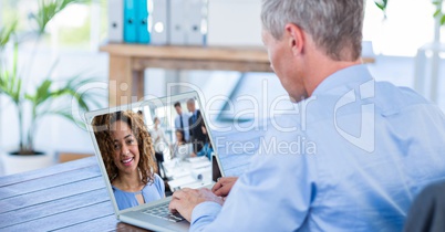 Businessman having video conference call with colleague on laptop