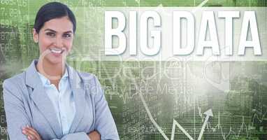 Smiling businesswoman with arms crossed by big data text on screen