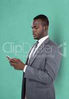 Businessman using smart phone against green background