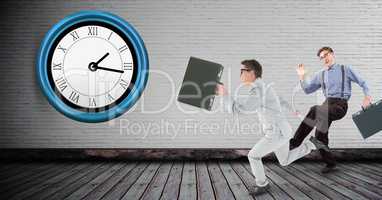 Full length of businessmen running late with clock on wall