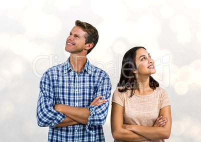 Smiling couple with arms crossed looking away