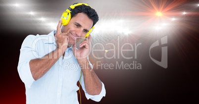 Smiling businessman listening to songs on headphones