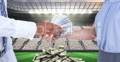 Midsection of people exchanging money at football stadium representing corruption