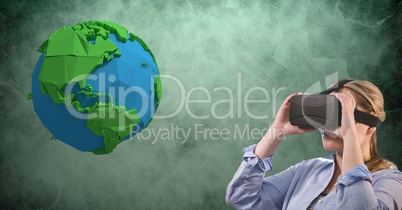 Businesswoman wearing VR glasses by low poly earth