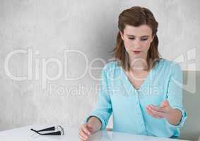 Young businesswoman holding invisible product in office